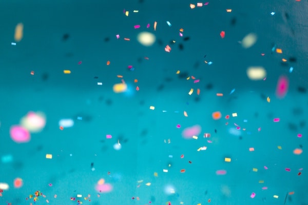 colorfull confetti on a teal blue background